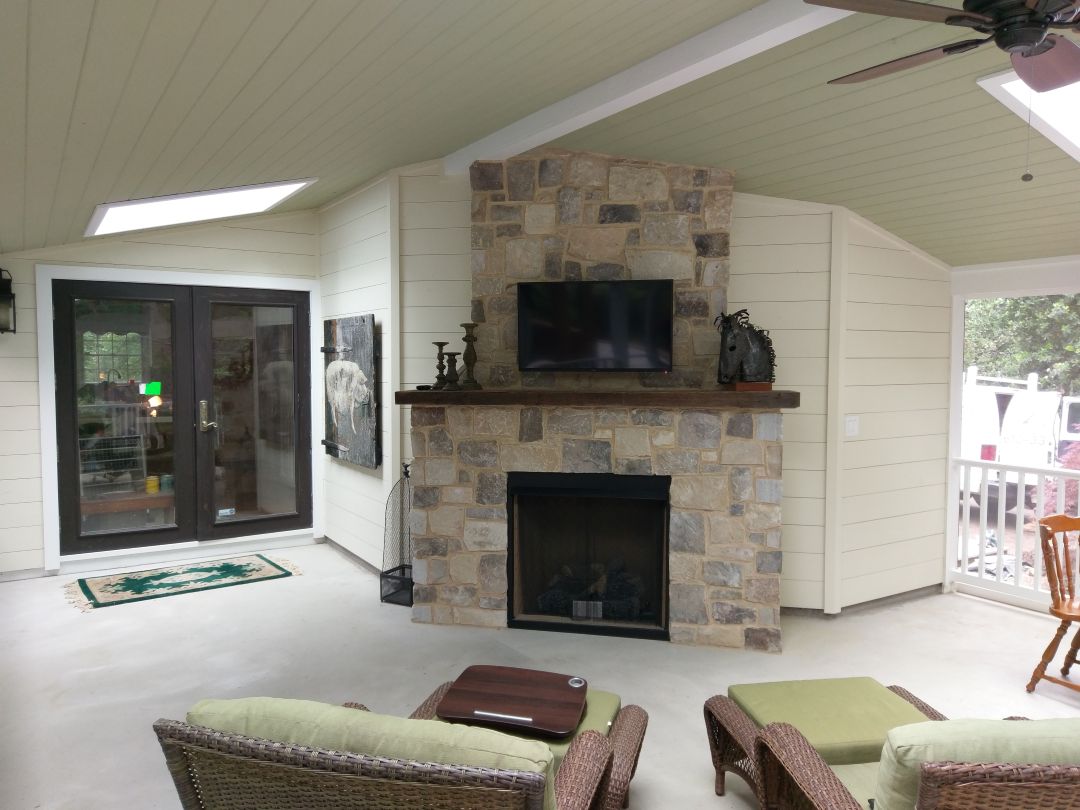 Screened porch interior with fireplace in Gladwyne, PA