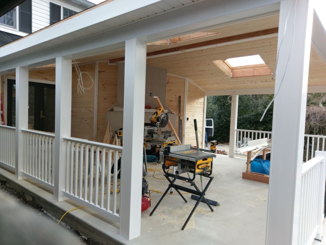 Screened porch with stone fireplace in Gladwyne