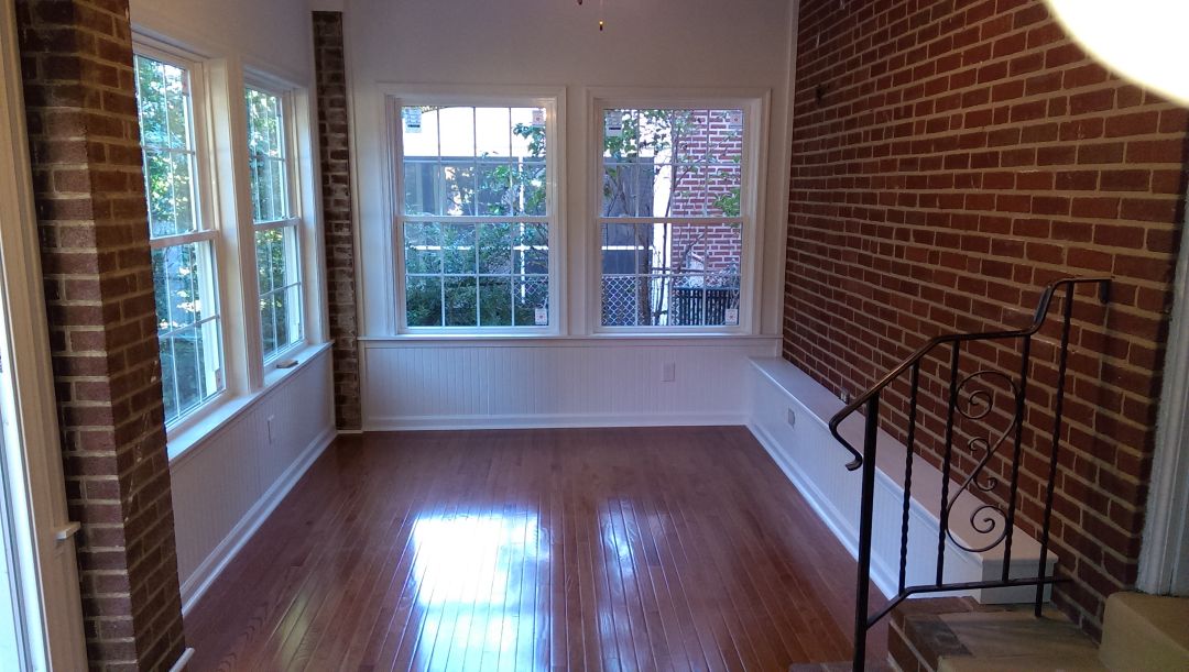 Three-season porch interior with large windows in Haverford, PA