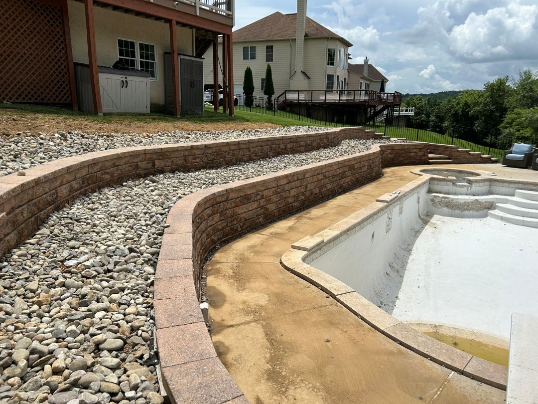 Curved retaining walls around a pool area in Glen Mills, PA