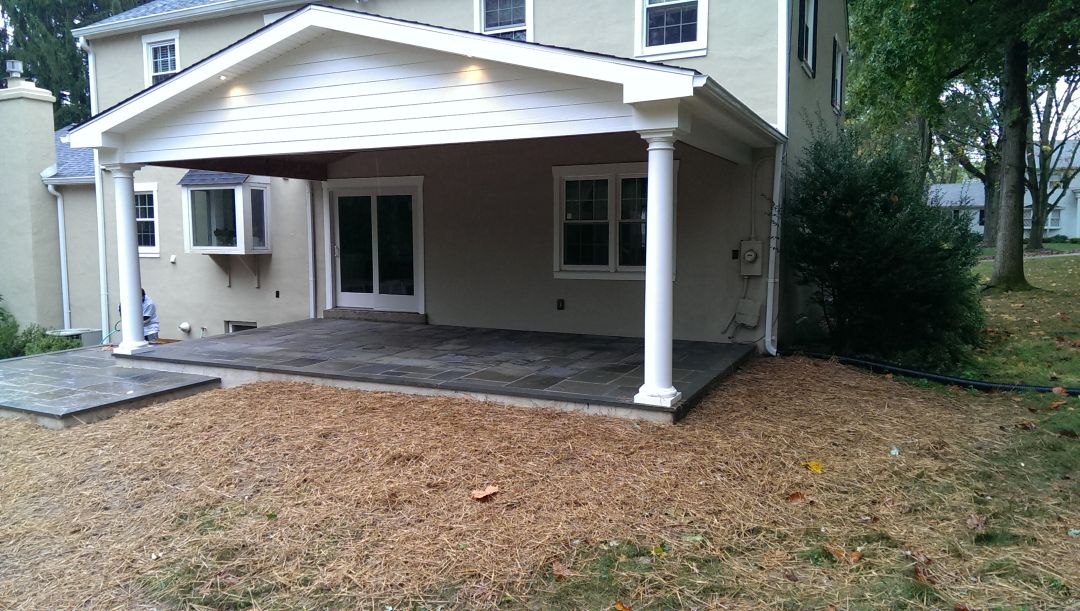 Bluestone patio with covered outdoor seating area in Bryn Mawr