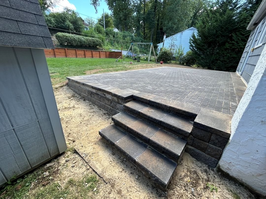 Raised paver patio with wide masonry steps in Newtown Square, PA