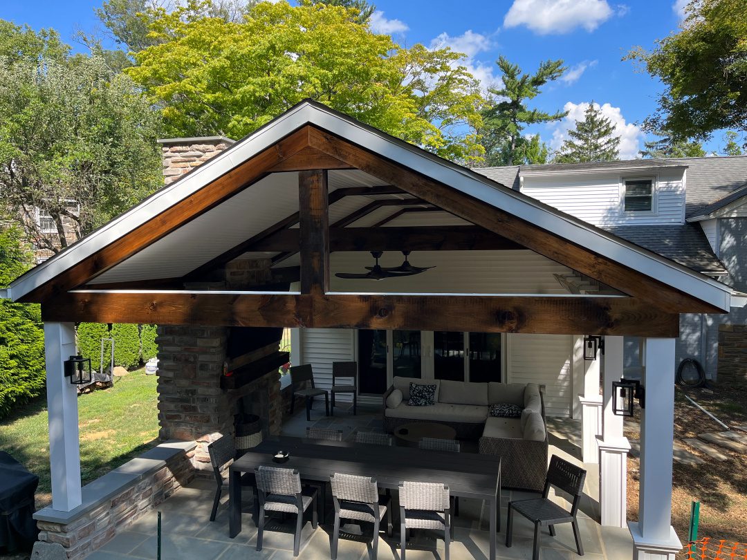 Covered porch with timber gable and fireplace